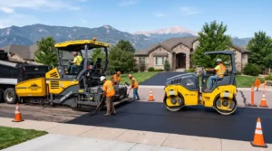 Professional asphalt driveway contractors installing a new residential driveway.