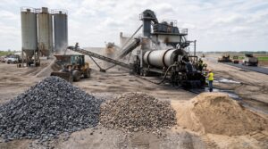 Raw aggregate materials and asphalt production equipment used to make asphalt pavement.